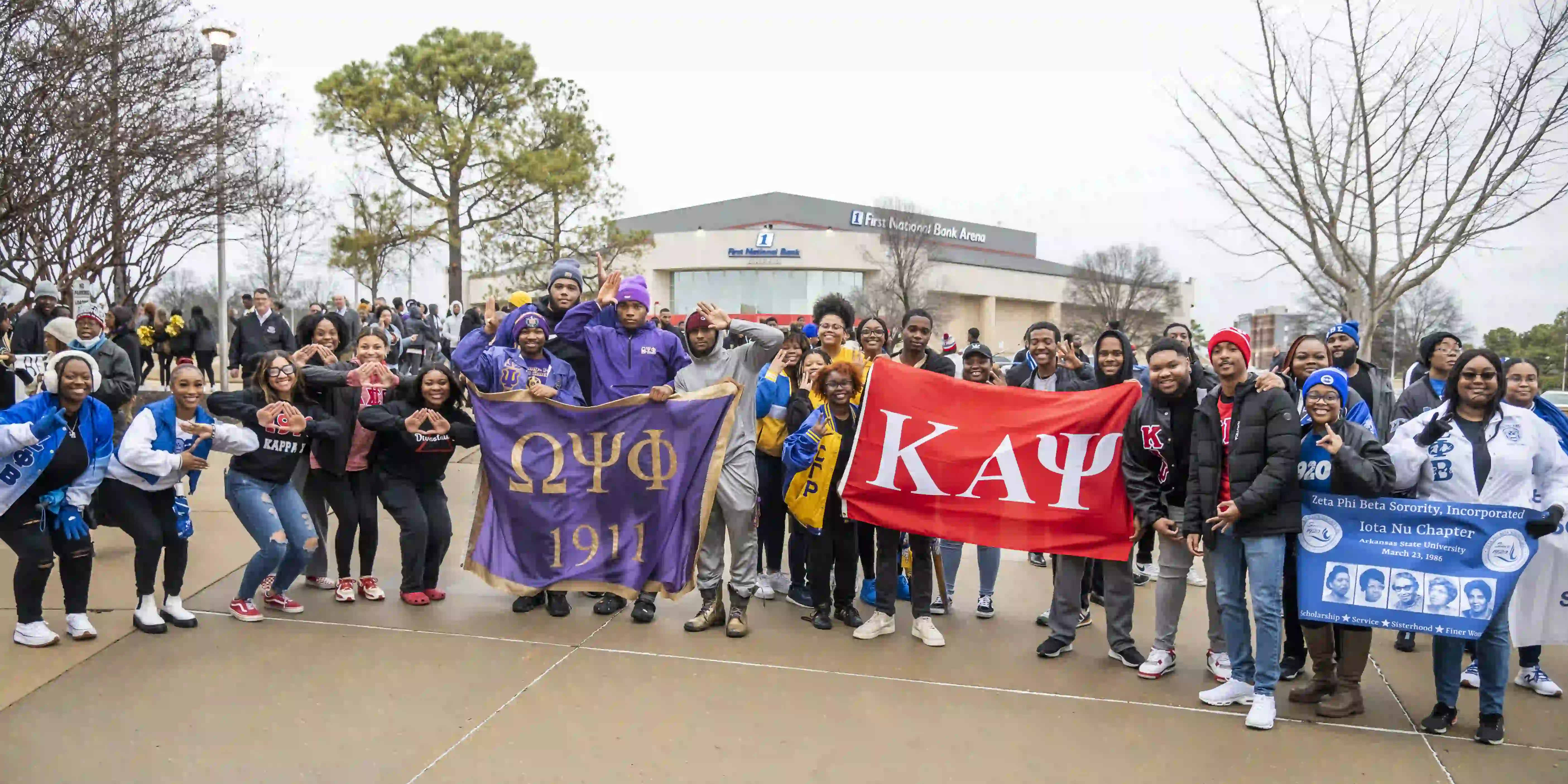 Greek students holding flags and posing at parade.