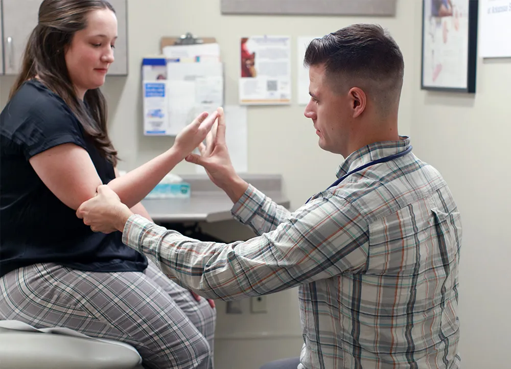 Doctor examing patient's arm