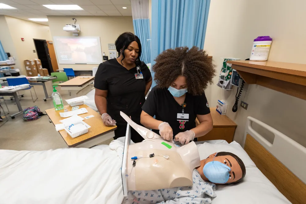 Nursing graduate with decorated graduation hat.