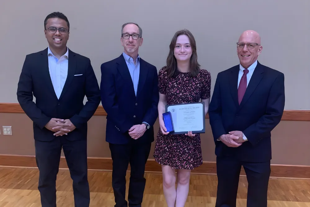 accounting professors giving a student an award