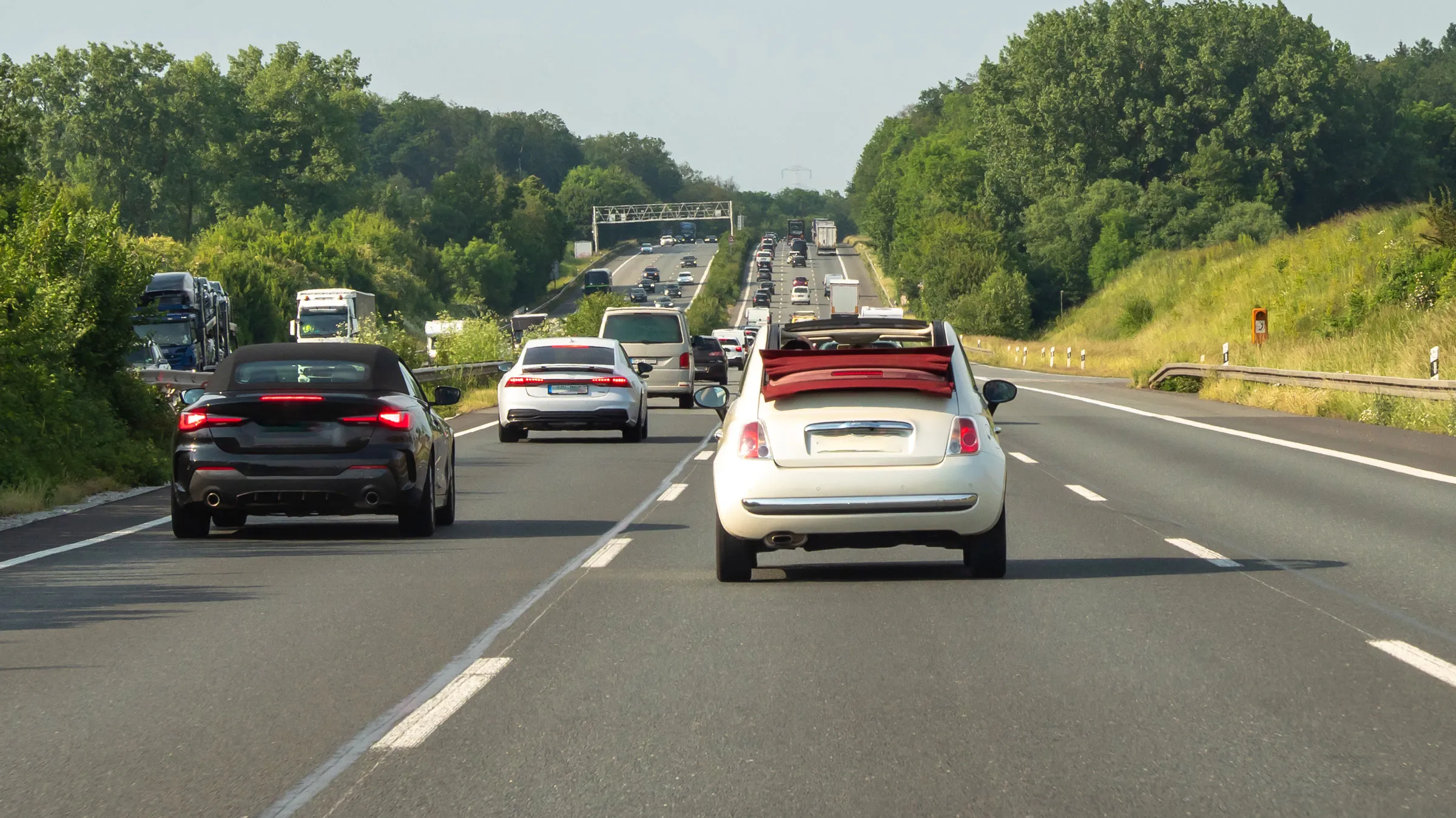 view from inside car, looking out front windshield toward road ahead