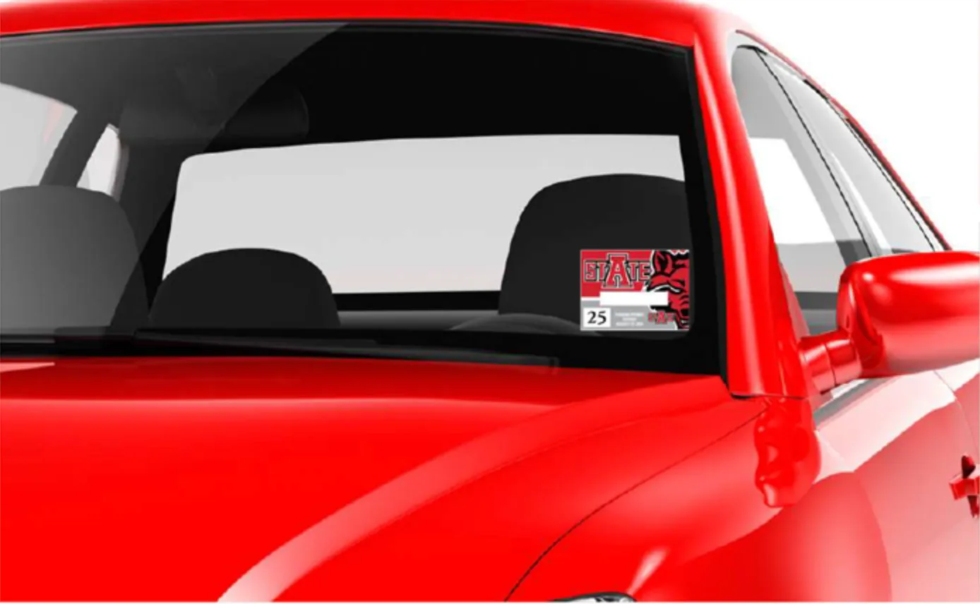 red car with parking permit displayed on windshield