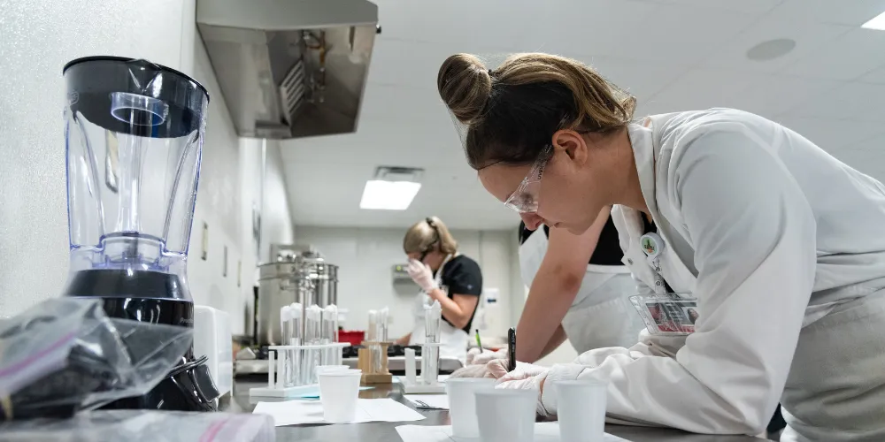A-State nutrition students working in a kitchen on portions