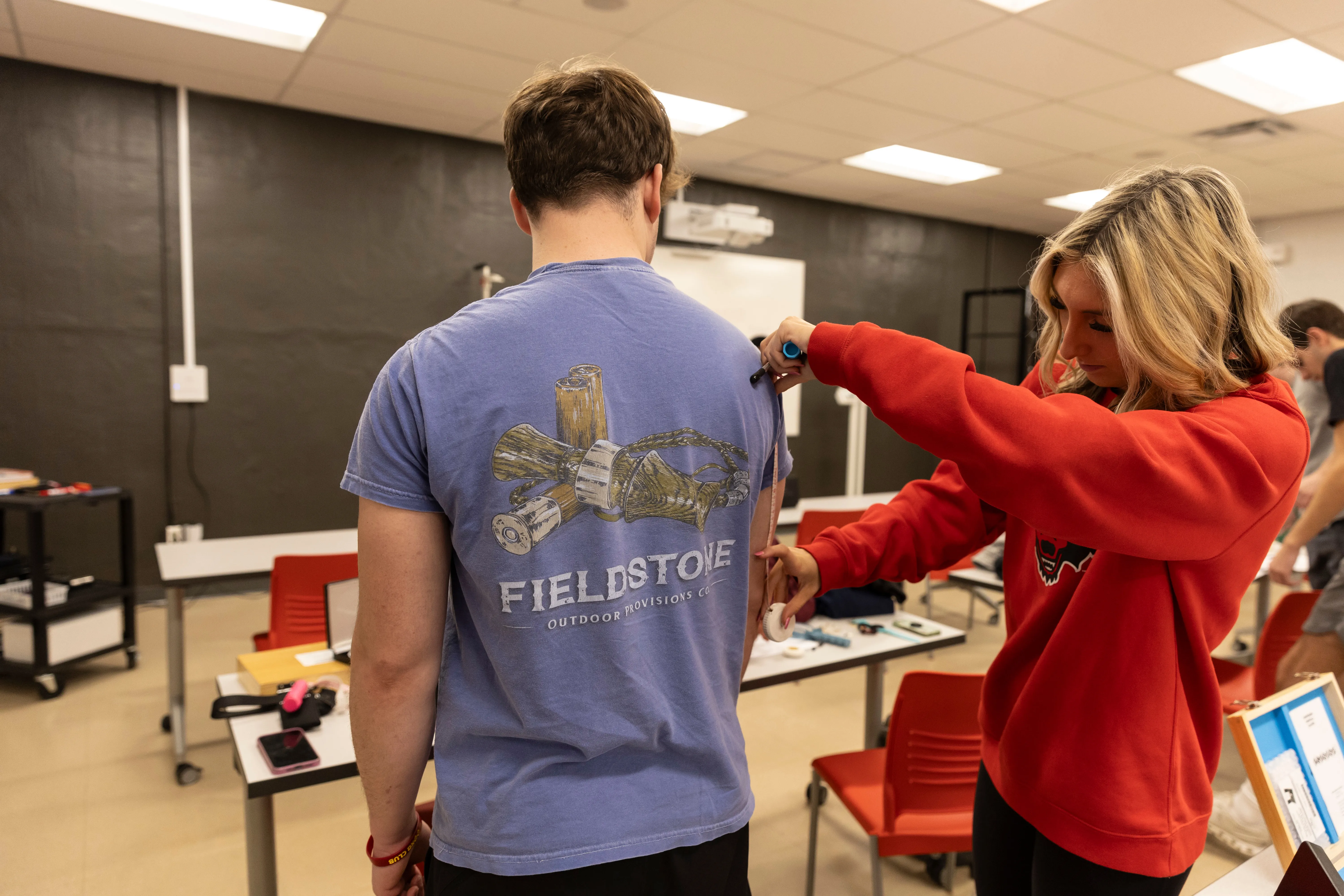 Physical Therapist student performing test on another student with bicycle machine.