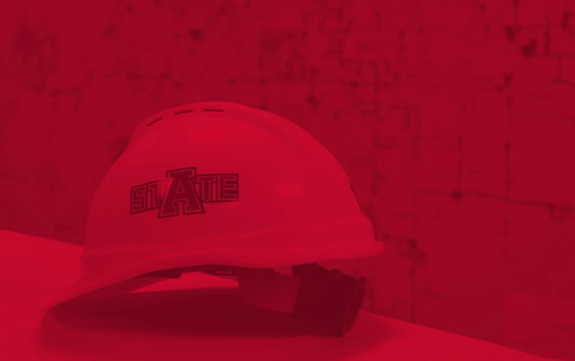 Arkansas State University Engineering Hard Hat next to city infrastructure map.