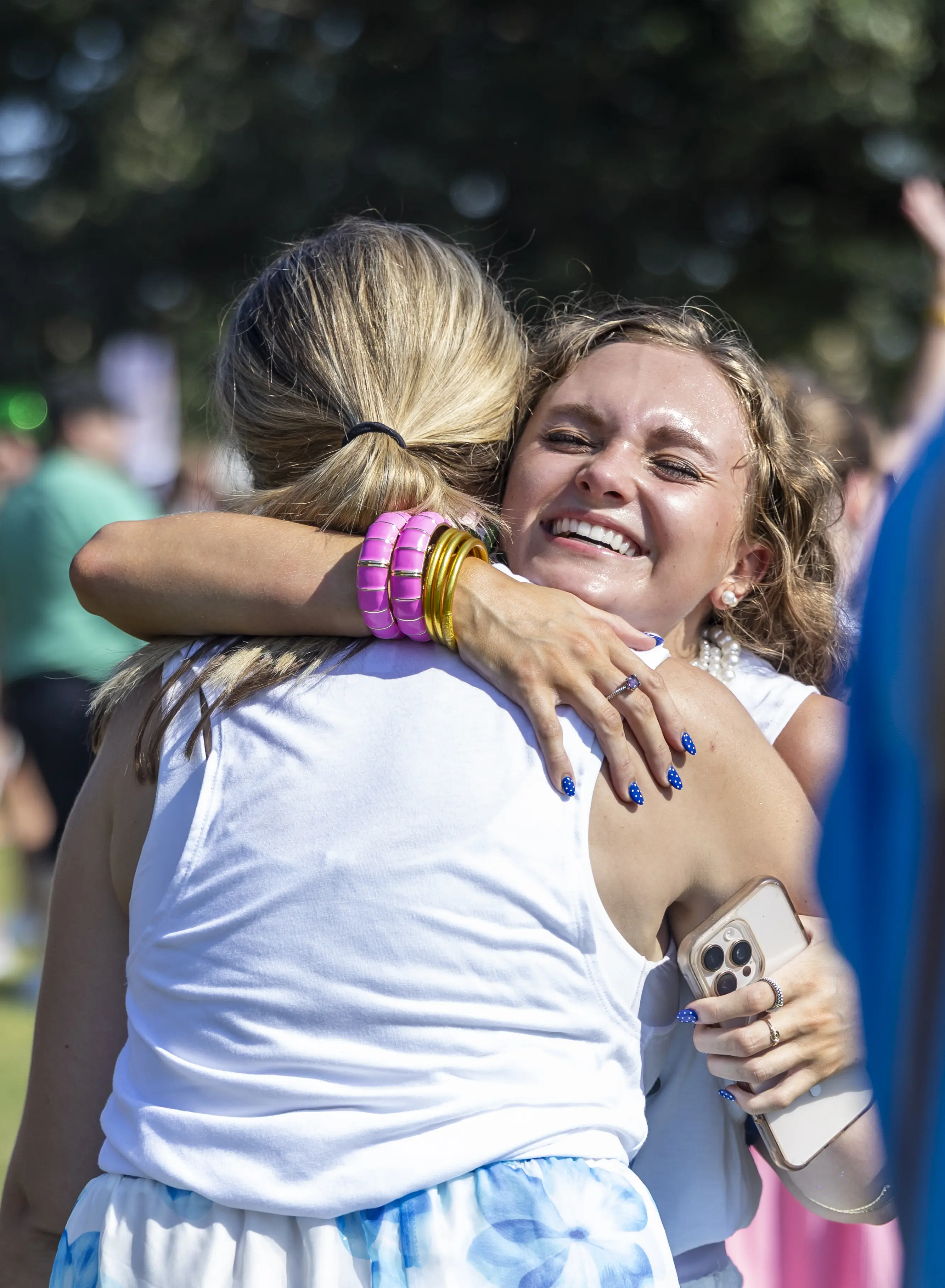 Sorority woman hugs new member at Sorority Bid Day.