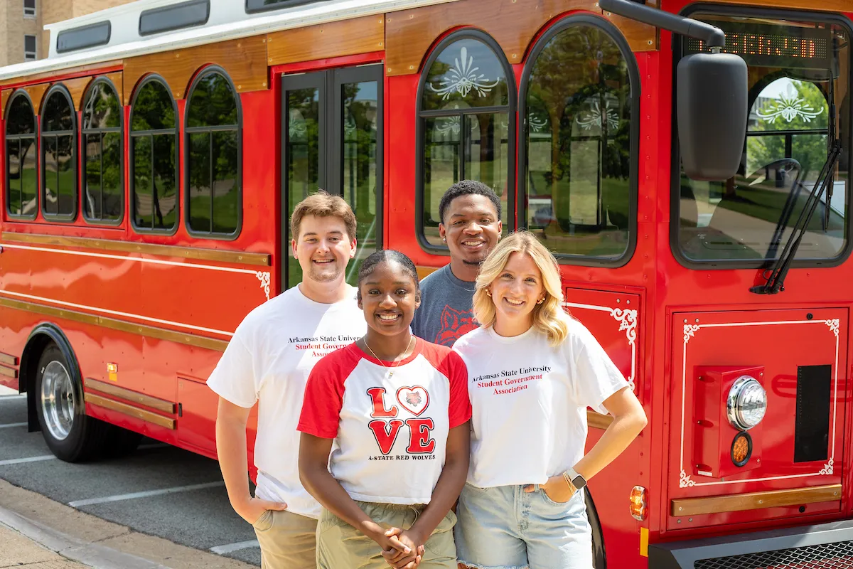 Student leaders stand in front of A-State’s new campus trolley