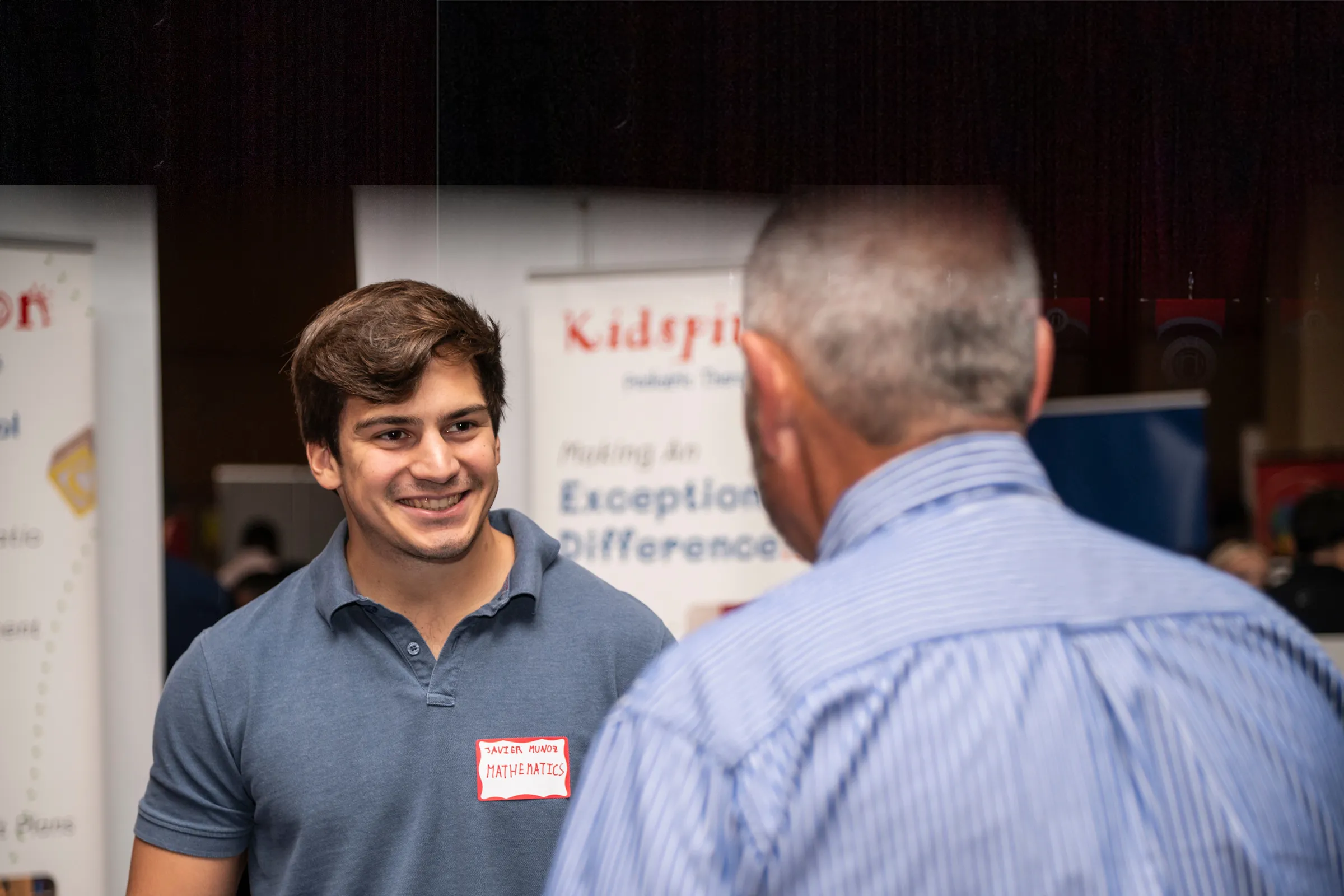 A student visits with a potential employer at an A-State career fair