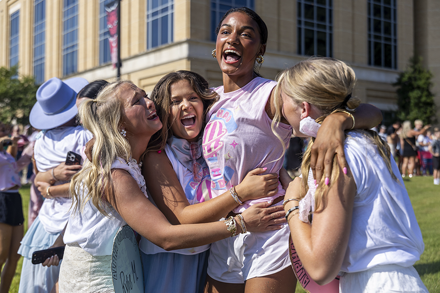 Students celebrating and hugging at Sorority Bid Day.