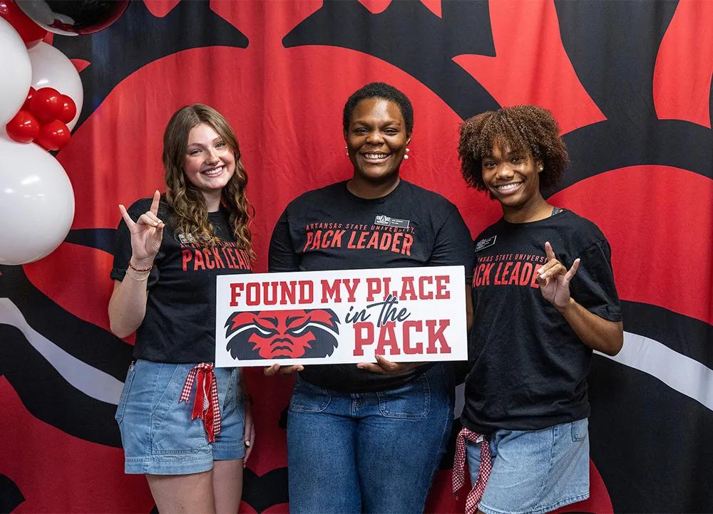 three smiling New Student Orientation leaders