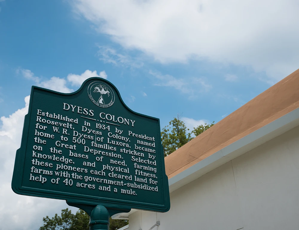 A sign with information about the history of the Dyess Colony.
