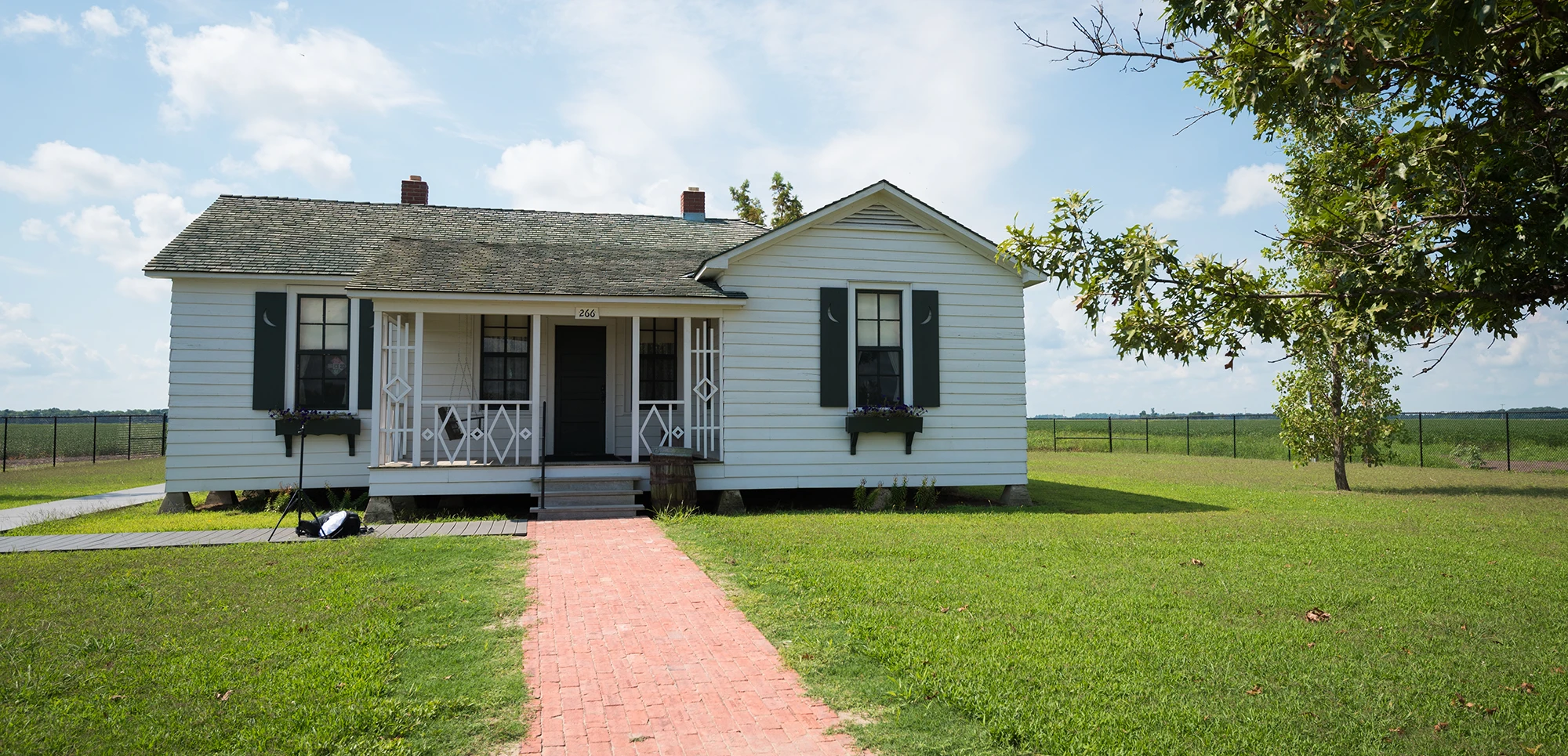The Johnny Cash Boyhood Home with a blue to red gradient overlay.