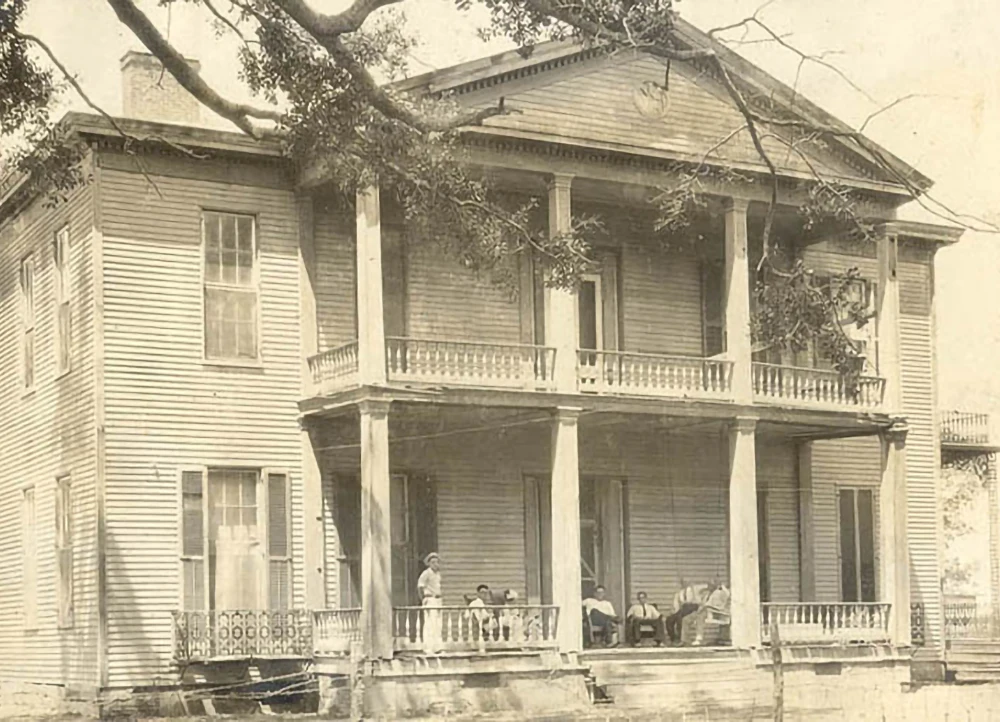 An antique photo of the Johnson family on the porch of the Lakeport Plantation home.
