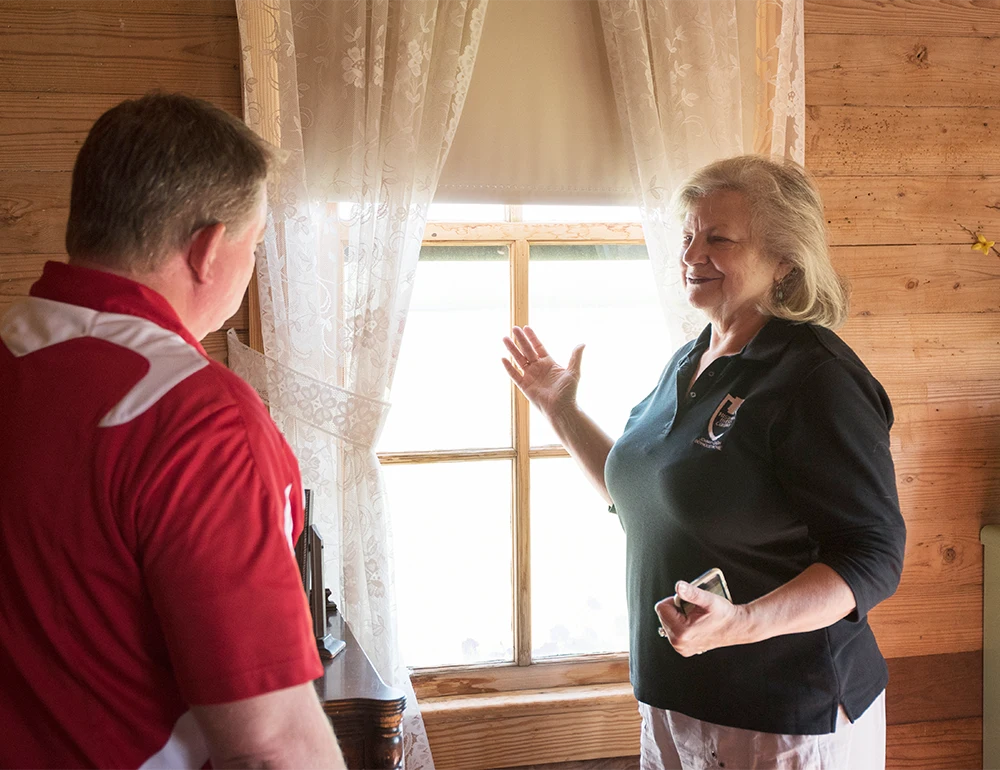 A tour guide giving a tour of the Johnny Cash Boyhood Home.