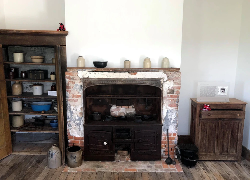 Fireplace and shelves within the plantation home.