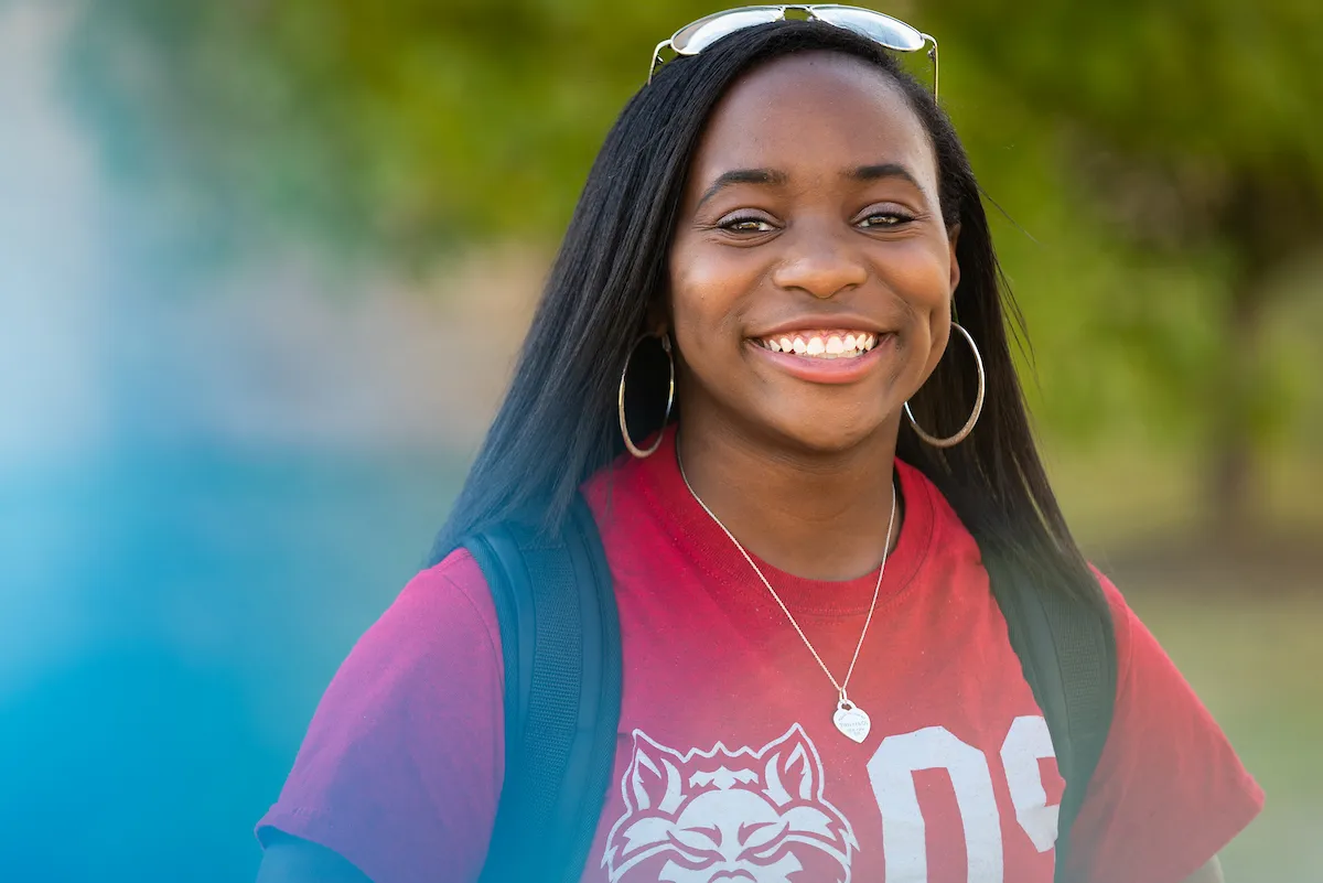 An honors student smiles on campus
