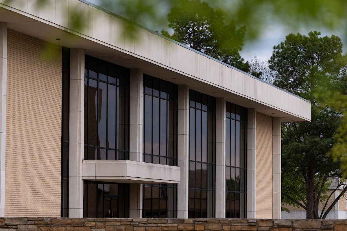 Administration Building on campus with large glass windows and columns.
