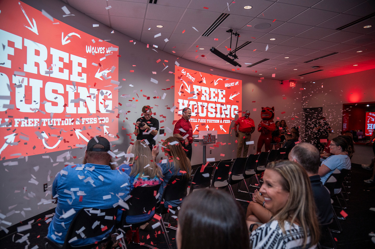 Confetti flies during A-State’s free housing and tuition announcement celebration event.